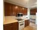 Traditional kitchen featuring cherry wood cabinets, modern oven and stovetop, and sleek countertops at 629 Pinetree Dr, Decatur, GA 30030