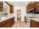A well-lit kitchen includes light countertops, dark wood cabinets, and stainless steel appliances at 629 Pinetree Dr, Decatur, GA 30030