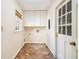 Functional laundry room with built-in cabinets, patterned tile floors, and a door to the outside at 629 Pinetree Dr, Decatur, GA 30030