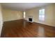 Spacious living room featuring hardwood floors, a fireplace, and large windows for natural light at 629 Pinetree Dr, Decatur, GA 30030