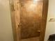 Shower with earth-toned tiles, a glass door, and a built-in seat at 629 Pinetree Dr, Decatur, GA 30030