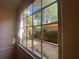 Sunny view from a window looking onto a private courtyard with lush greenery and a brick fence at 629 Pinetree Dr, Decatur, GA 30030