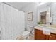 Bathroom featuring a shower-tub combo, toilet, and a single sink vanity at 114 Oakview Psge, Canton, GA 30114