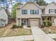 Charming townhome with stone accents, blue shutters, and a one-car garage at 114 Oakview Psge, Canton, GA 30114