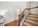 Inviting foyer features hardwood floors, a staircase, and a closet for storage at 114 Oakview Psge, Canton, GA 30114