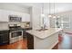 Modern kitchen boasts granite countertops, stainless steel appliances, and pendant lighting at 114 Oakview Psge, Canton, GA 30114
