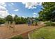 Community playground featuring swings, slides, and climbing structures on a cushioned ground at 114 Oakview Psge, Canton, GA 30114