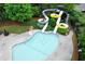 Aerial view of a vibrant pool area featuring water slides, sun loungers, and lush greenery at 114 Oakview Psge, Canton, GA 30114