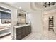 Bathroom boasts a large vanity with marble countertop, a large mirror and tiled floors at 3511 Roxboro Ne Rd, Atlanta, GA 30326