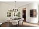Cozy dining area with contemporary chandelier, wine storage, and backyard views through a large window at 3511 Roxboro Ne Rd, Atlanta, GA 30326