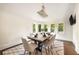 Elegant dining room featuring a marble-top table, modern chandelier, and an abundance of natural light at 3511 Roxboro Ne Rd, Atlanta, GA 30326