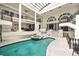 Indoor pool and spa with multiple seating areas, staircases, and access to main living areas at 3511 Roxboro Ne Rd, Atlanta, GA 30326