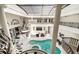Bright indoor pool area featuring a large swimming pool, skylight, and access to the main living areas at 3511 Roxboro Ne Rd, Atlanta, GA 30326