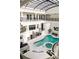 Bright indoor pool and spa area with seating, balconies, skylights, and access to multiple levels at 3511 Roxboro Ne Rd, Atlanta, GA 30326