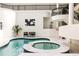 Indoor pool and hot tub area with elegant lighting and sleek contemporary design at 3511 Roxboro Ne Rd, Atlanta, GA 30326