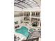 Expansive indoor pool with integrated spa and stairs, surrounded by lounge areas and staircase at 3511 Roxboro Ne Rd, Atlanta, GA 30326