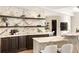 Modern kitchen featuring marble backsplash, countertops, custom cabinetry, and stylish floating shelves at 3511 Roxboro Ne Rd, Atlanta, GA 30326