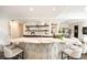 Kitchen island with marble countertop and decorative woodwork, and adjacent living and dining areas at 3511 Roxboro Ne Rd, Atlanta, GA 30326