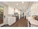 Bright kitchen boasting white cabinetry, marble countertops, stainless steel appliances, and wood floors at 3511 Roxboro Ne Rd, Atlanta, GA 30326