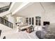 Bright, open living room featuring a fireplace, bar area, and stylish staircase at 3511 Roxboro Ne Rd, Atlanta, GA 30326