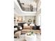 Bright living room featuring modern furnishings, stylish decor, and a decorative wrought iron balcony at 3511 Roxboro Ne Rd, Atlanta, GA 30326