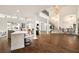 Spacious open-concept living area with dark hardwood floors, marble bar, and wrought iron staircase at 3511 Roxboro Ne Rd, Atlanta, GA 30326