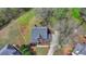 Aerial view of a home that includes trees and a manicured front lawn at 220 Carriage Station Dr, Lawrenceville, GA 30046