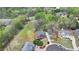An aerial view shows a traditionally styled home with mature trees and landscaping in a suburban neighborhood at 220 Carriage Station Dr, Lawrenceville, GA 30046