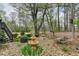 Beautiful backyard with a water fountain, wooded area, and stairs leading to the deck at 220 Carriage Station Dr, Lawrenceville, GA 30046