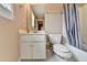Modest bathroom with a standard toilet, sink, and shower with gray curtain at 220 Carriage Station Dr, Lawrenceville, GA 30046