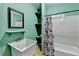 Cozy bathroom with a combination sink and bathtub, along with decorative shelves at 220 Carriage Station Dr, Lawrenceville, GA 30046