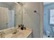 Bathroom featuring a single sink vanity and a mirror reflecting the toilet and entry door at 220 Carriage Station Dr, Lawrenceville, GA 30046