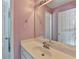 Bathroom featuring a single sink vanity and a mirror reflecting the toilet and entry door at 220 Carriage Station Dr, Lawrenceville, GA 30046