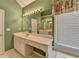 Bright bathroom featuring a long vanity with a built-in desk area and a large mirror at 220 Carriage Station Dr, Lawrenceville, GA 30046