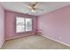 Bedroom with a ceiling fan, carpet flooring and a large window at 220 Carriage Station Dr, Lawrenceville, GA 30046