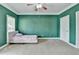 Bedroom with green walls, carpet flooring and a bed near a window at 220 Carriage Station Dr, Lawrenceville, GA 30046