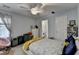 Bedroom with ceiling fan, neutral walls, and a window overlooking the backyard at 220 Carriage Station Dr, Lawrenceville, GA 30046