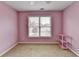 Bedroom with a ceiling fan, carpet flooring and a large window at 220 Carriage Station Dr, Lawrenceville, GA 30046