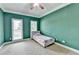 Bedroom with green walls, carpet flooring and two windows at 220 Carriage Station Dr, Lawrenceville, GA 30046