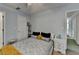 Bedroom with ceiling fan, neutral walls, and a window overlooking the backyard at 220 Carriage Station Dr, Lawrenceville, GA 30046