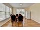 Bright breakfast area with large windows, wood floors, and a refrigerator at 220 Carriage Station Dr, Lawrenceville, GA 30046