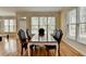 Breakfast area featuring wood floors, large windows, and a view of the backyard at 220 Carriage Station Dr, Lawrenceville, GA 30046