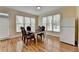 Bright breakfast area with large windows, wood floors, and a white refrigerator at 220 Carriage Station Dr, Lawrenceville, GA 30046