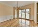 Bright dining room with hardwood floors, wainscoting, and a stylish chandelier at 220 Carriage Station Dr, Lawrenceville, GA 30046