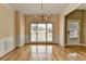 Bright dining room featuring hardwood floors, wainscoting, and a chandelier at 220 Carriage Station Dr, Lawrenceville, GA 30046