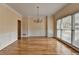 Spacious dining room with hardwood floors, chandelier, and large window at 220 Carriage Station Dr, Lawrenceville, GA 30046