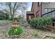 Exterior view of a brick house featuring a water fountain and stairs leading to an upper deck at 220 Carriage Station Dr, Lawrenceville, GA 30046
