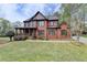 Beautiful brick home with a large front lawn, a covered porch, and manicured landscaping at 220 Carriage Station Dr, Lawrenceville, GA 30046