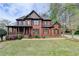 Charming brick home with a well-maintained lawn, covered porch, and shuttered windows at 220 Carriage Station Dr, Lawrenceville, GA 30046