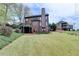 Back exterior view of home with spacious lawn, rear deck and great curb appeal at 220 Carriage Station Dr, Lawrenceville, GA 30046